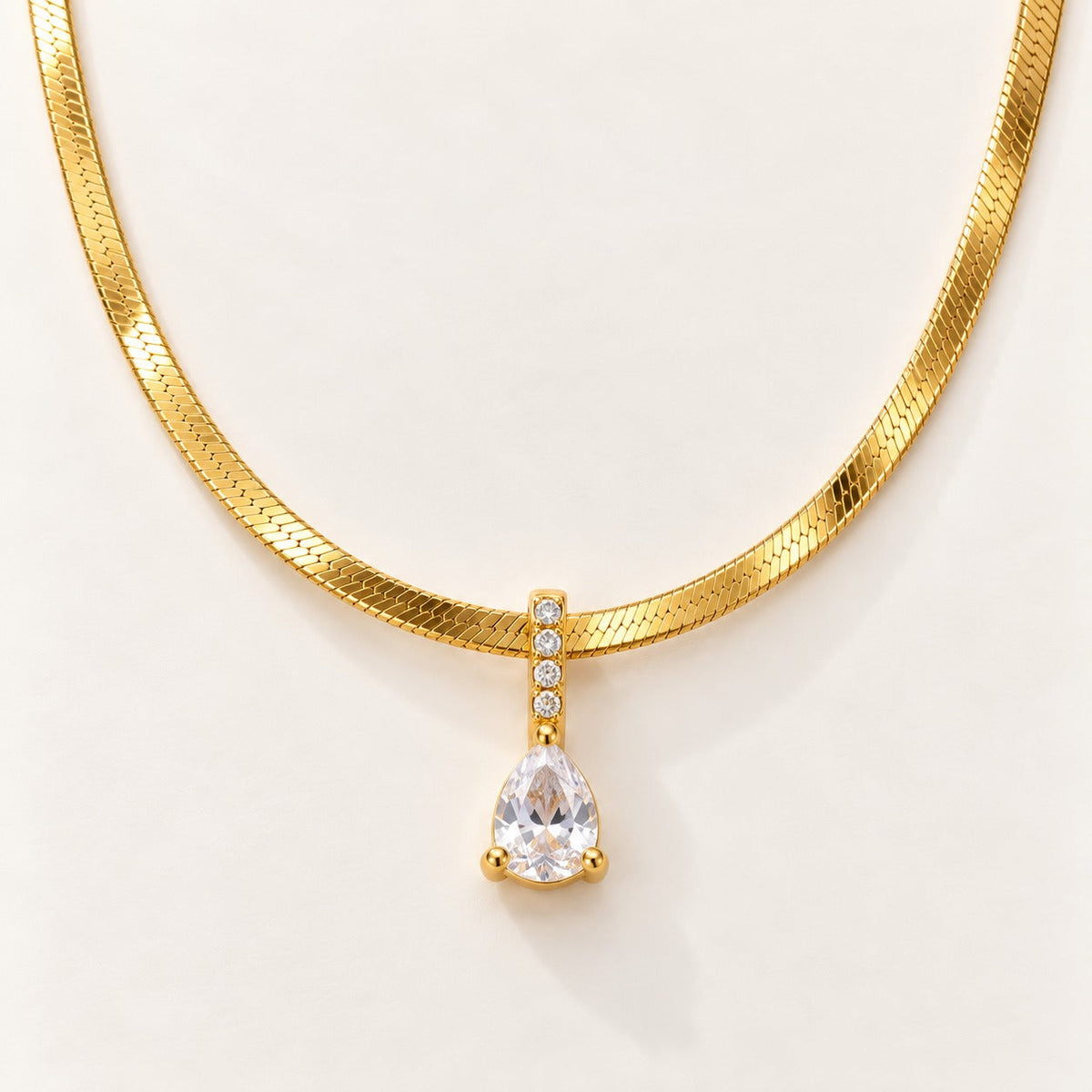 Crystal Drop Necklace by NuNu: a clear crystal drop on a flat snake chain, anti-tarnish gold tone