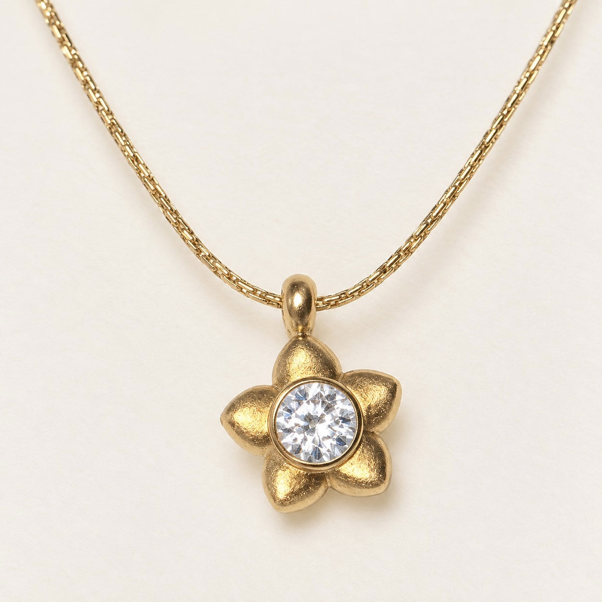 Golden Blossom Necklace product photo on cream