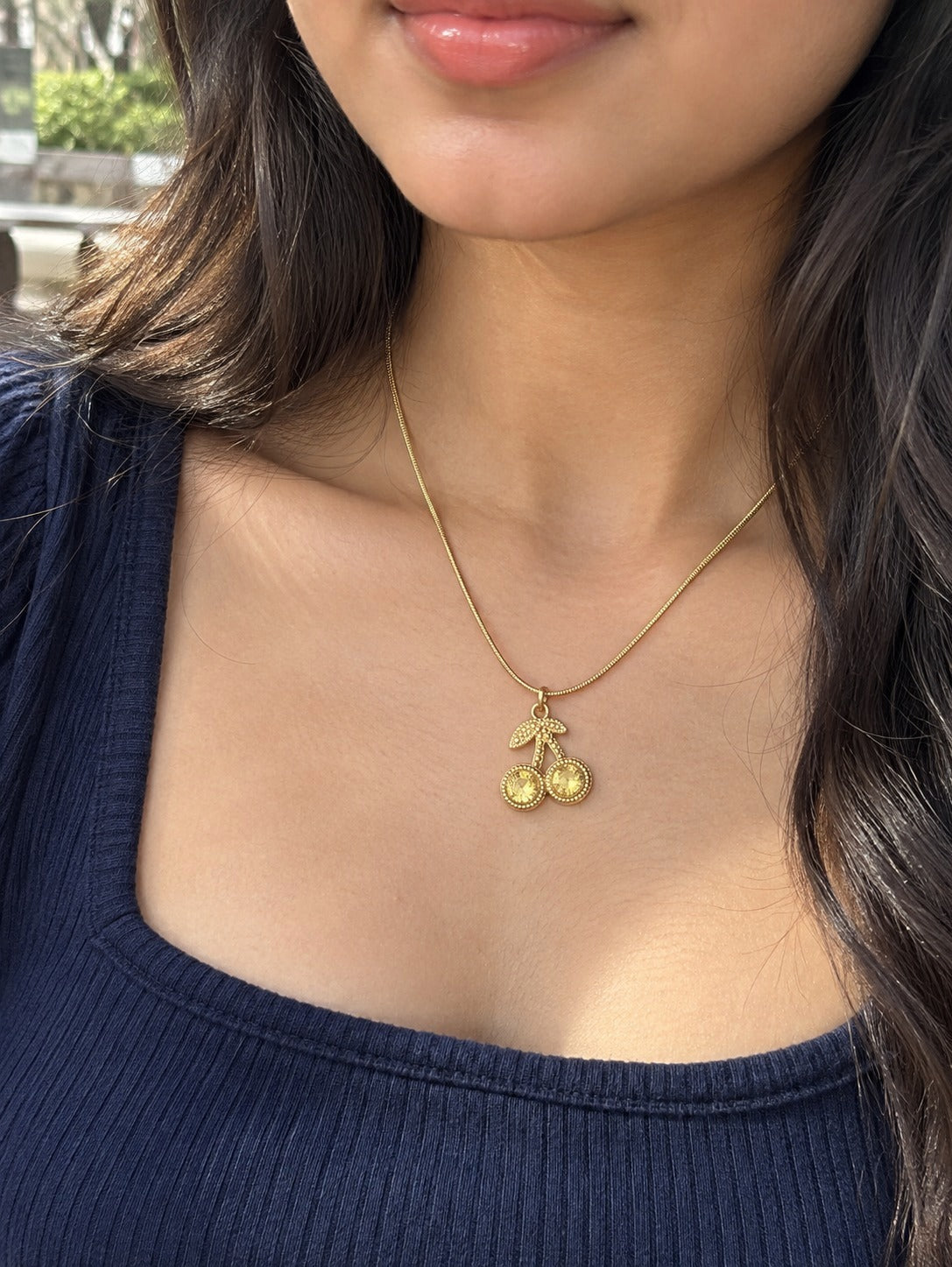 Golden Cherry Necklace worn by a model