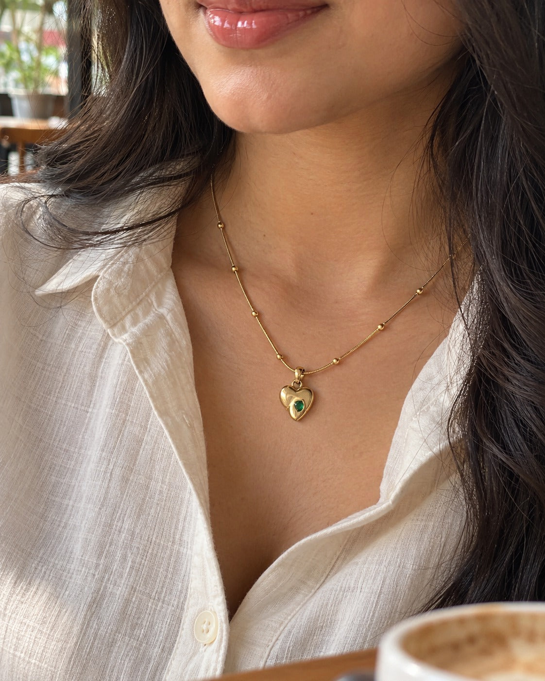 Golden Heart Emerald Necklace worn by a model