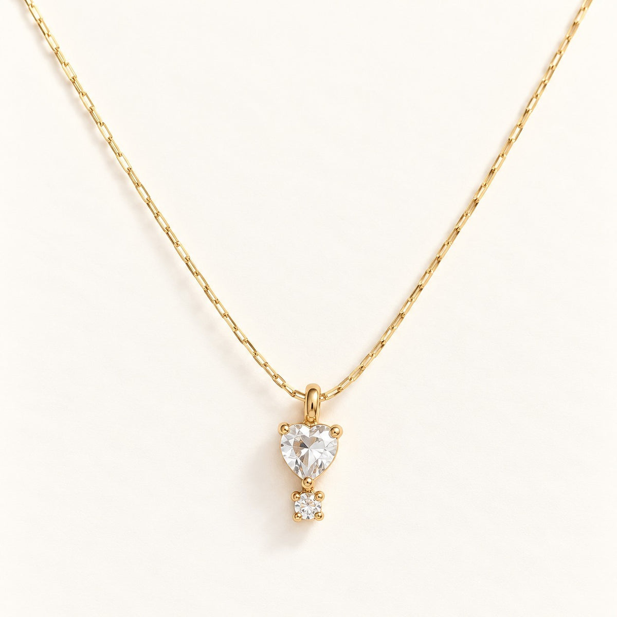 Crystal Heart Drop Necklace on a cream background