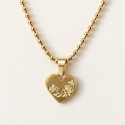 Engraved Heart Necklace on a cream background