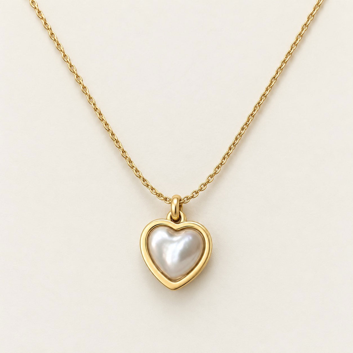 Pearl Heart Frame Necklace on a cream background