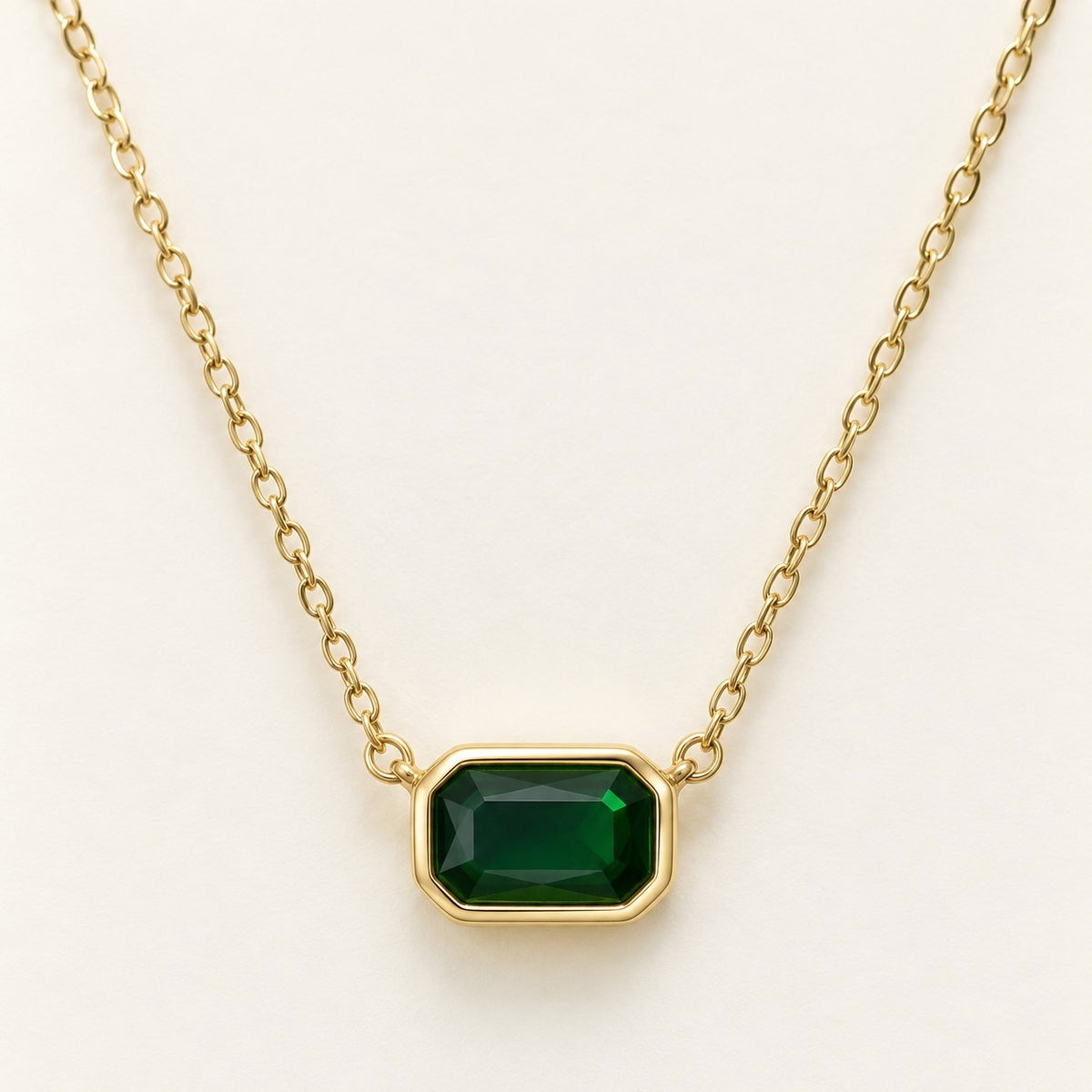Rectangle Stone Bezel Necklace in emerald green on a cream background
